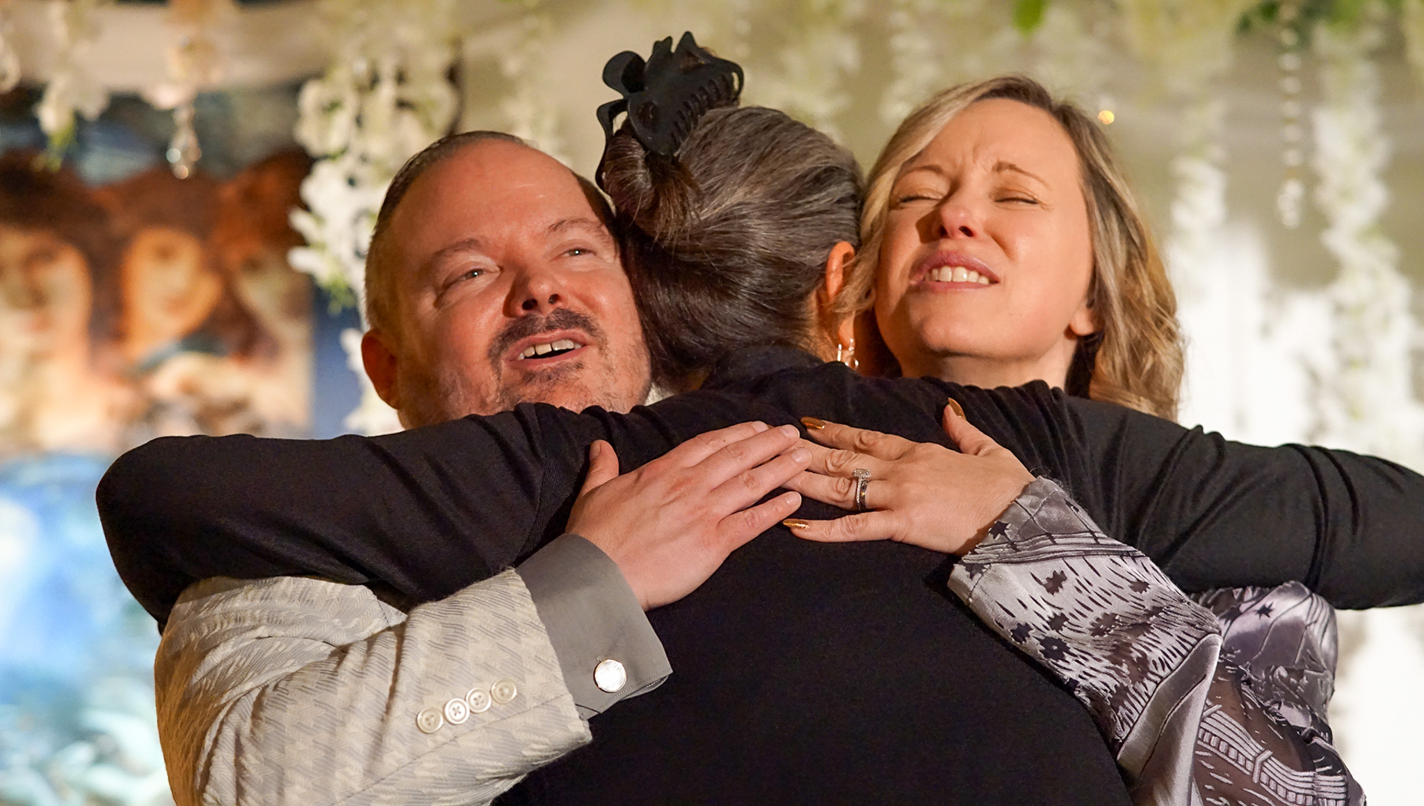 Matt & Joy embracing an attendee after the event