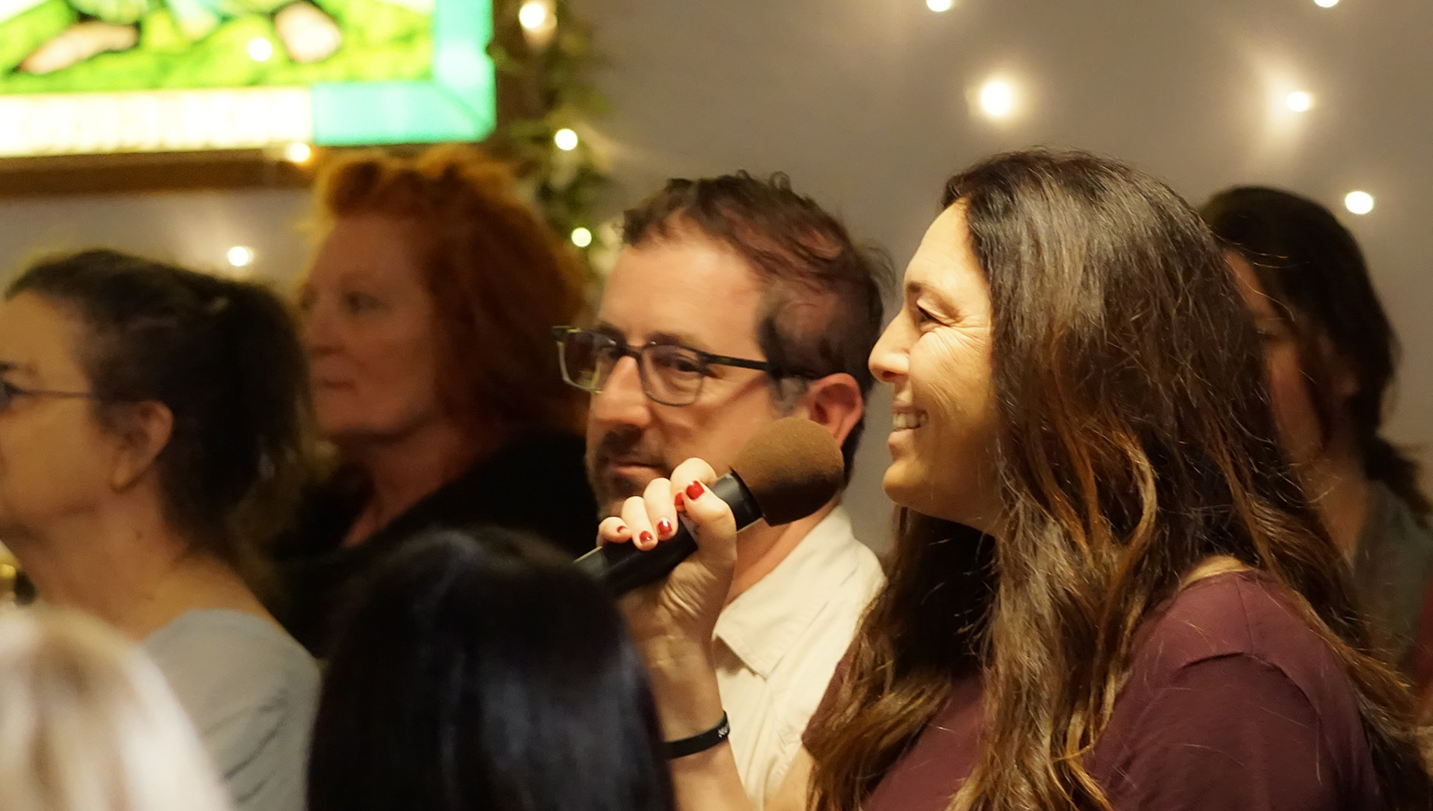 Attendee sharing her breakthrough moment with the mic